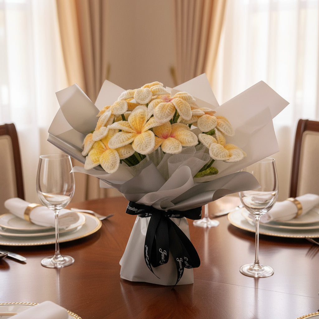 Bouquet of yellow flowers on a table with glasses and plates