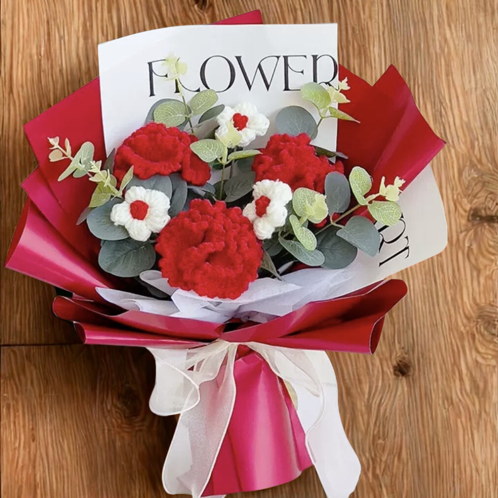 Bouquet of red, white, and green flowers with a 'FLOWER' magazine on a wooden surface