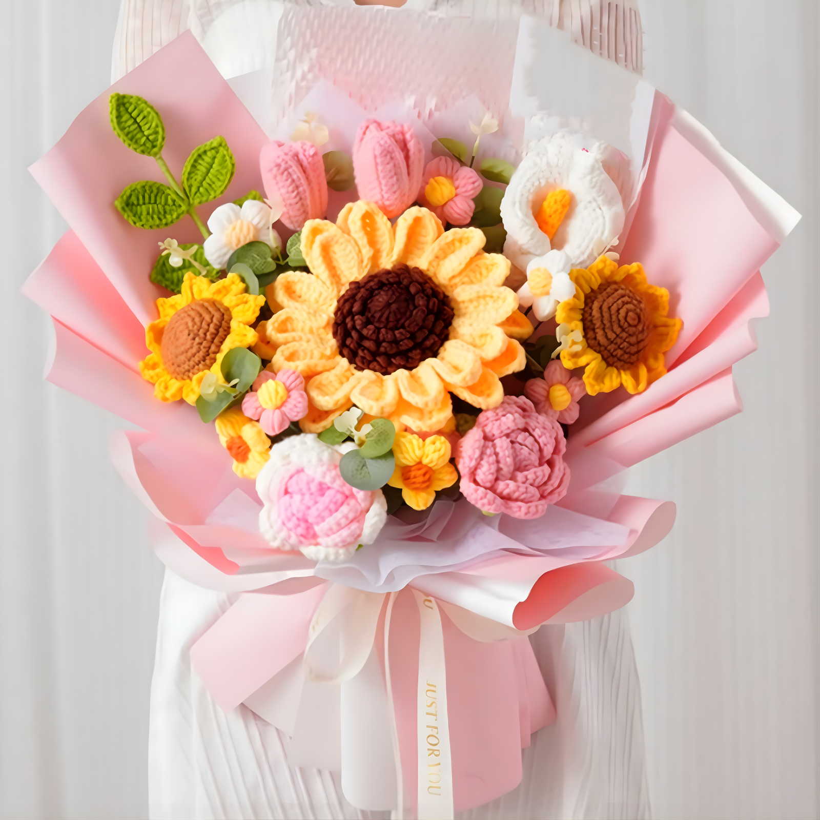 Bouquet of crocheted flowers in various colors on a white background