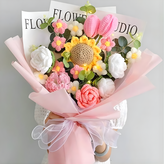 Bouquet of decorative flowers with a pink ribbon on a gray background