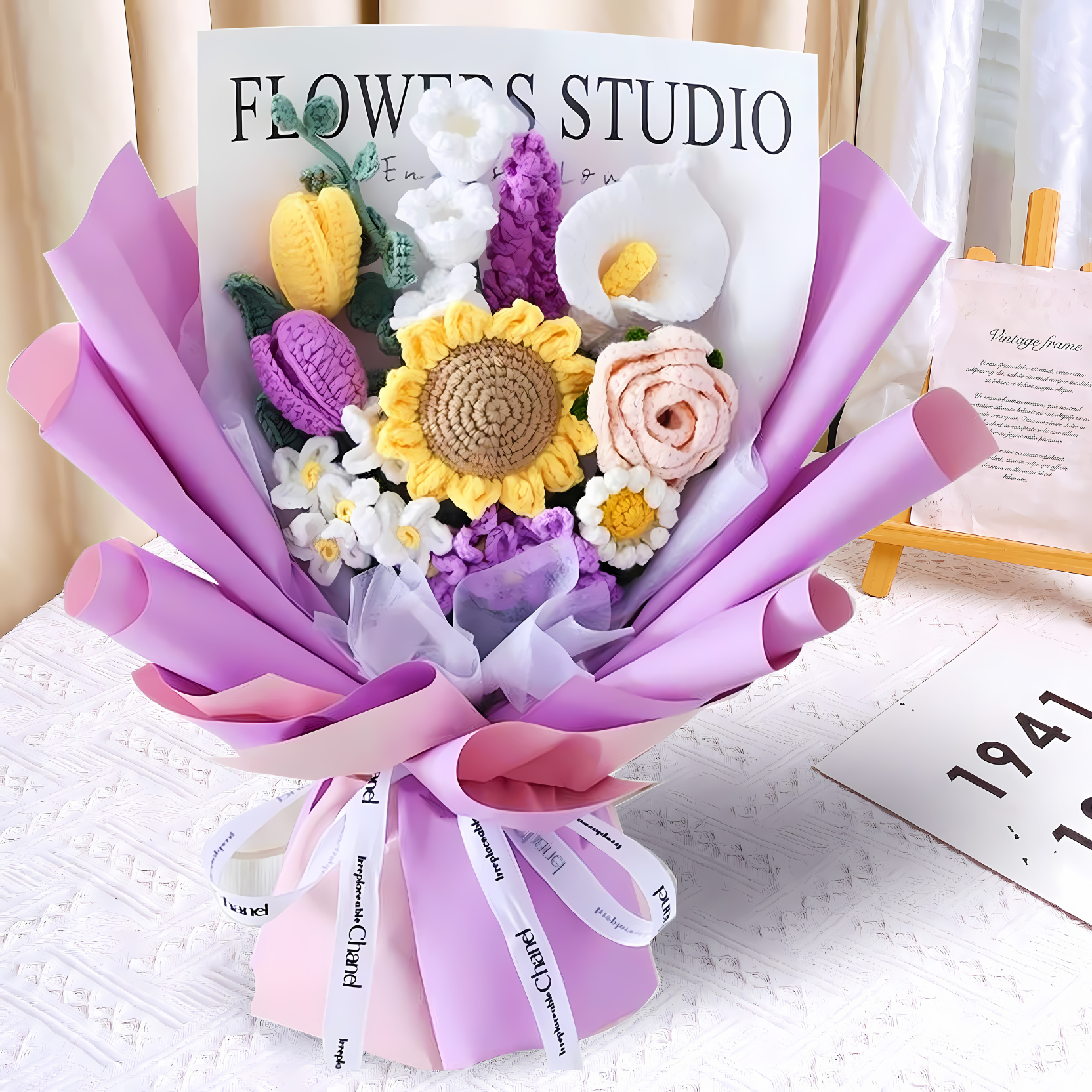Bouquet of crocheted flowers with 'Flowers Studio' sign in the background