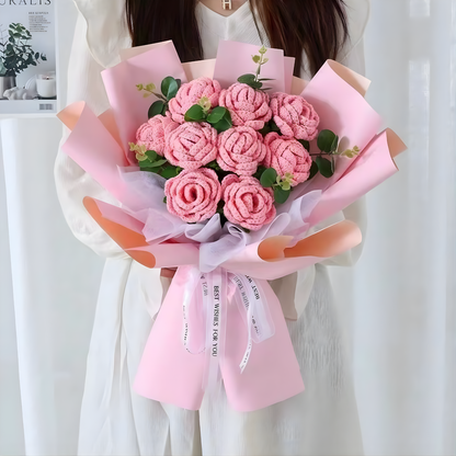 Bouquet of pink flowers wrapped in pink paper with a white ribbon.