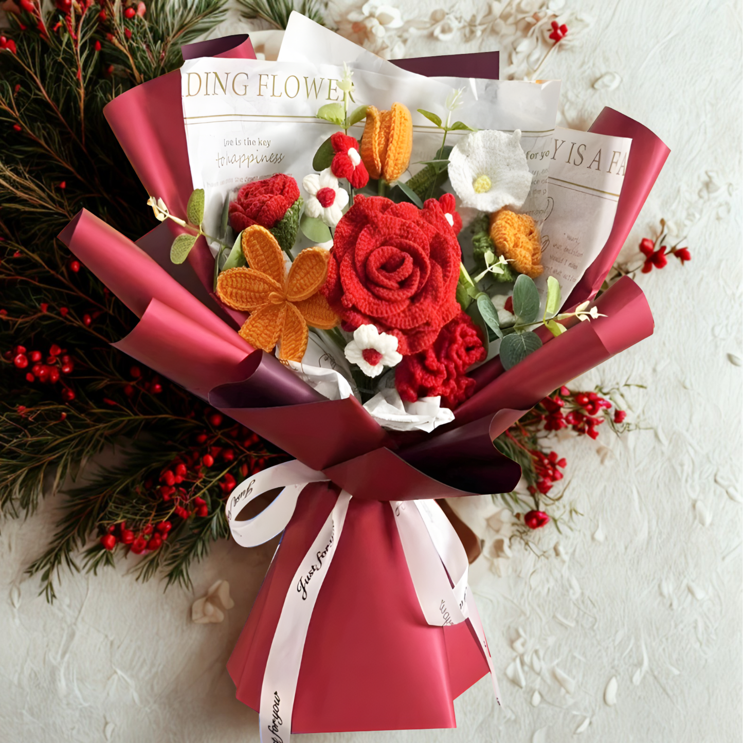 Bouquet of flowers with red and orange colors, wrapped in pink paper with a white ribbon on a light background.