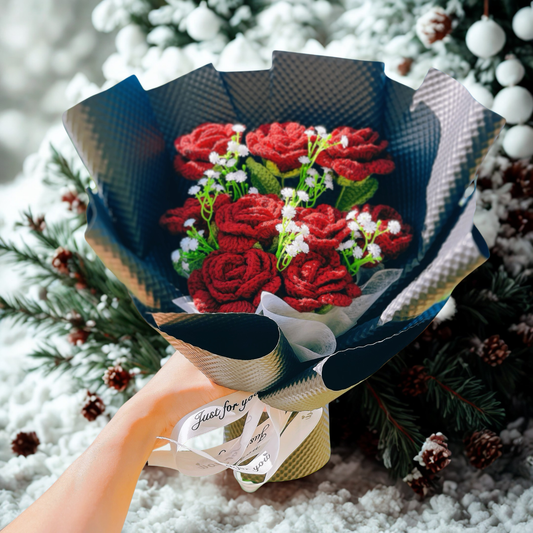 Bouquet of red flowers wrapped in blue paper with a snowy background
