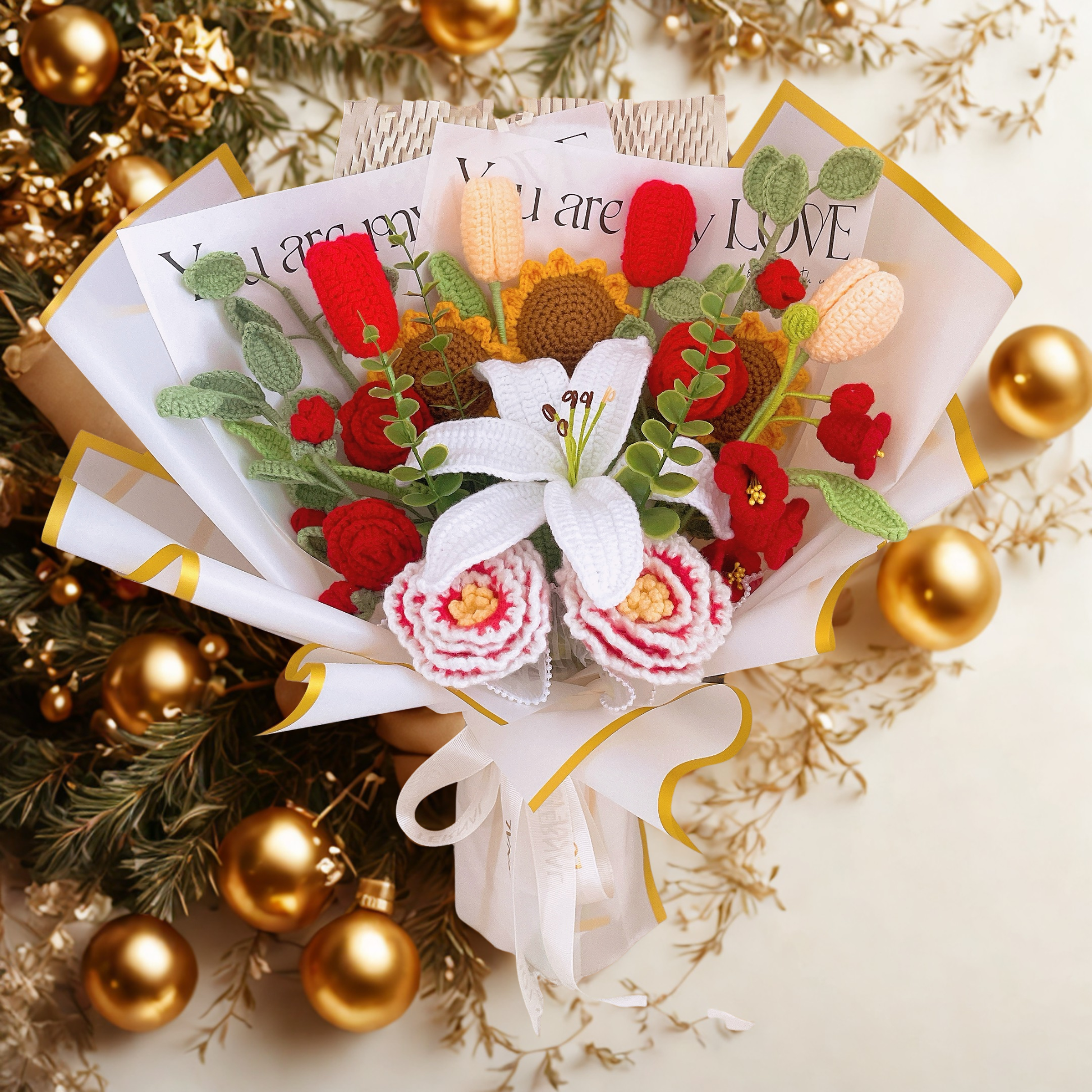 Decorative bouquet with flowers and cards surrounded by gold ornaments and greenery