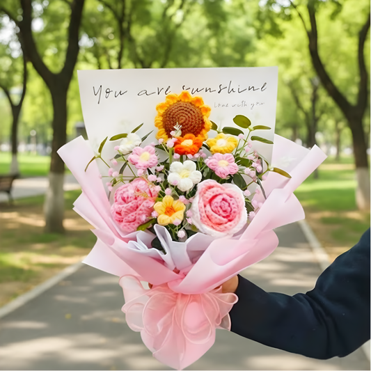Bouquet of flowers with a card reading 'You are sunshine' held outdoors.